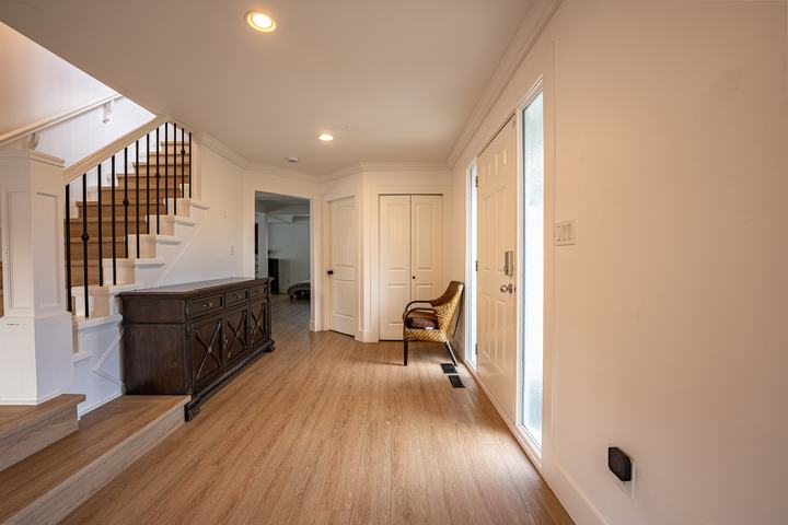 Entry hall with oak stairs and a dark wood console