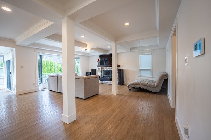 Family room with a coffered ceiling and fireplace