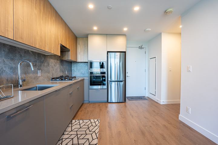 Condo kitchen with wood cabinets and stainless appliances